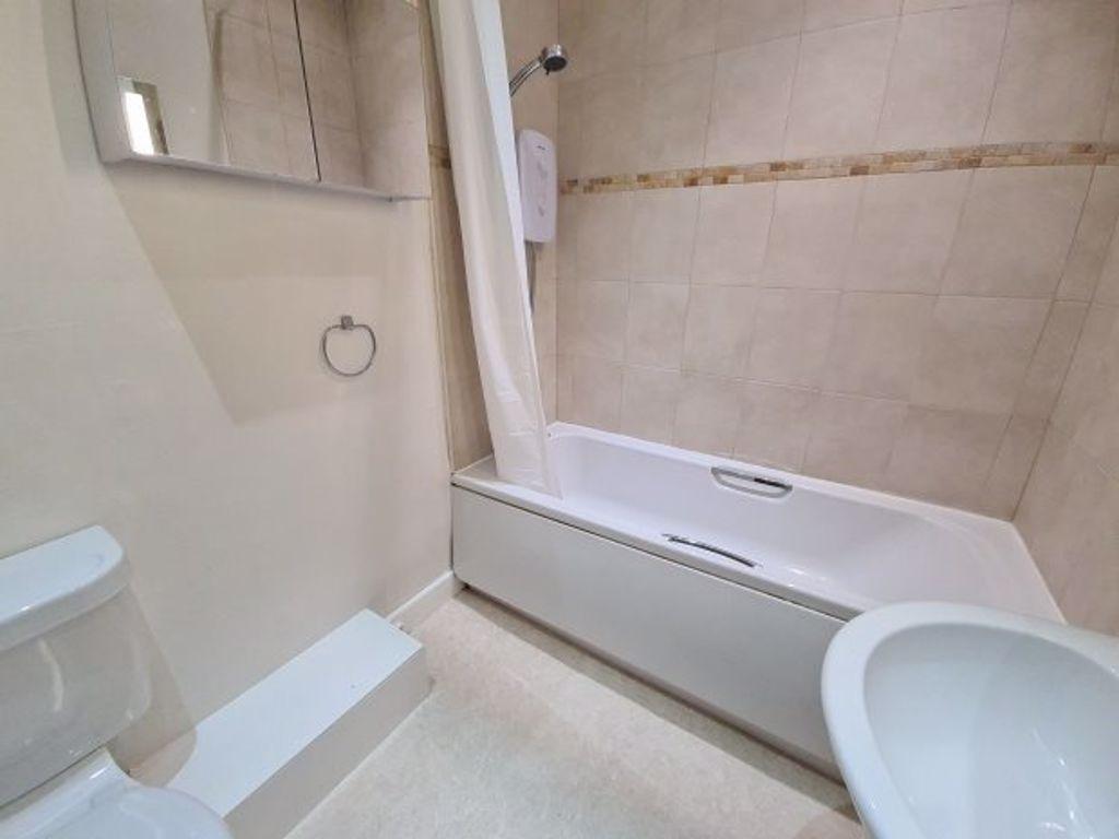 Bright, well-maintained bathroom with a modern ...