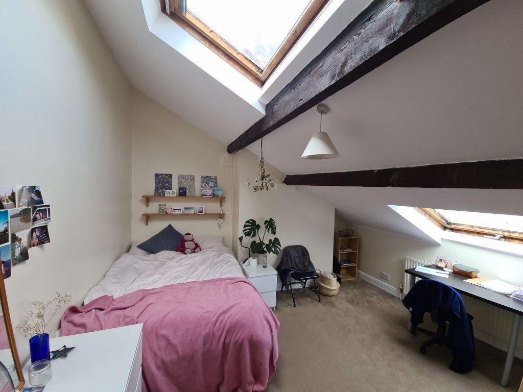 Bright attic-style double bedroom with sloped c...