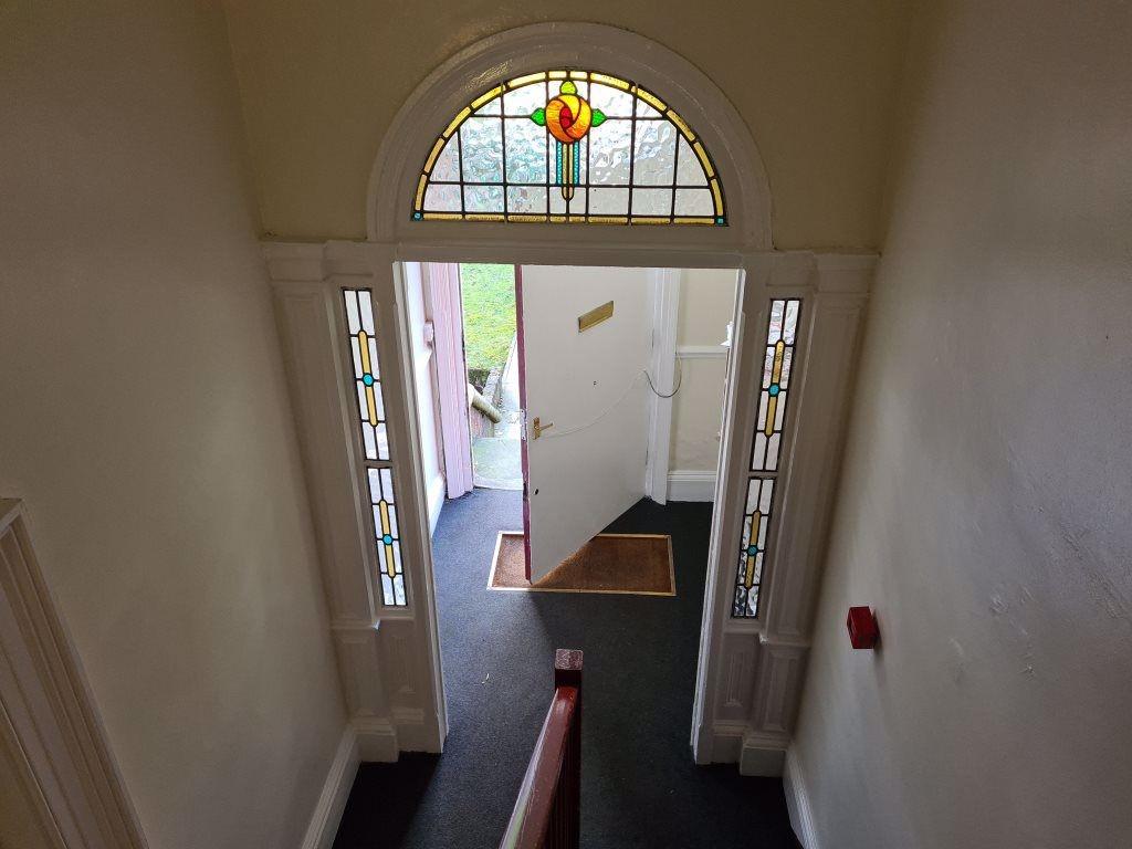 Bright entrance hallway with decorative stained...