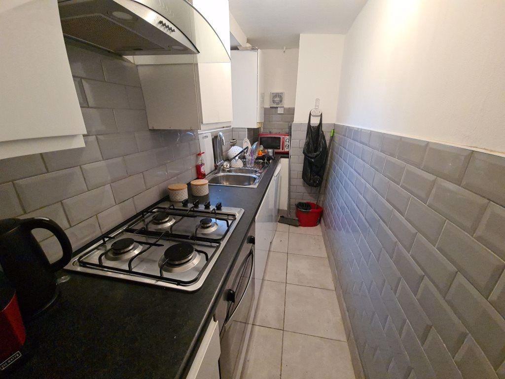 Bright, modern galley kitchen with tiled splash...