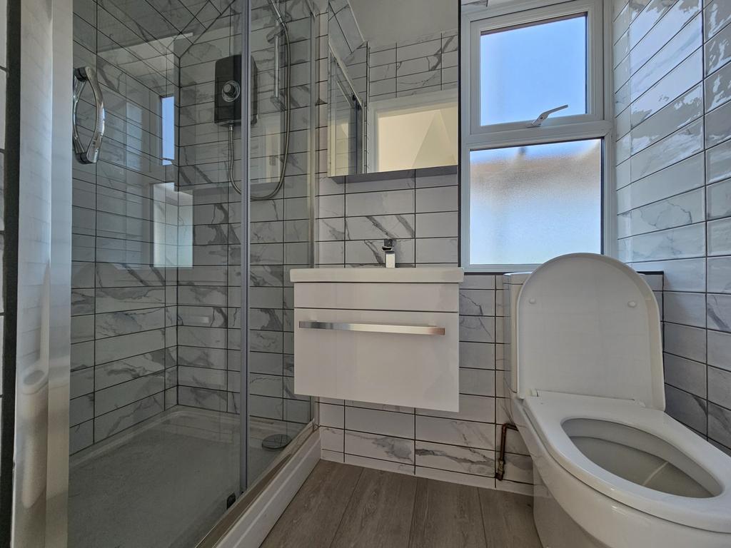 Bright, modern bathroom with a walk-in shower, ...