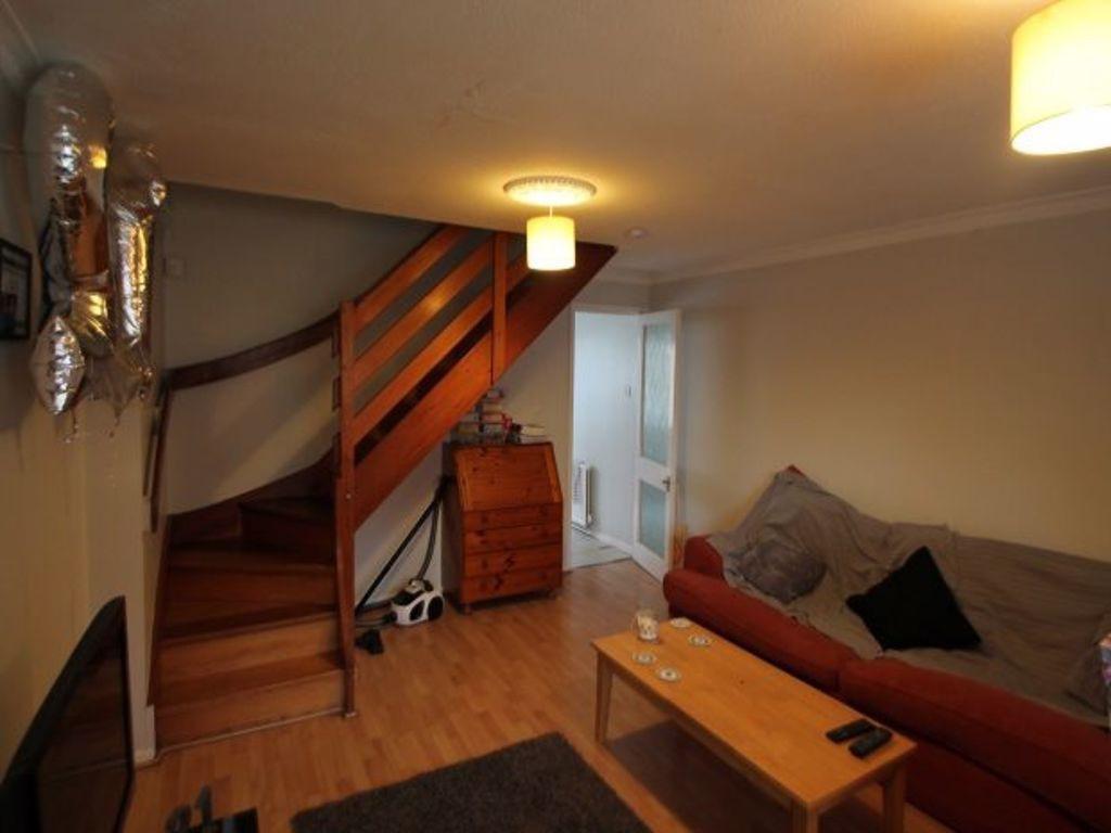 Cozy living room with wooden flooring, a comfor...