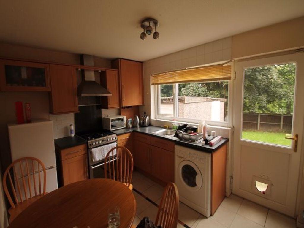 Warm, well-equipped kitchen with wooden cabinet...