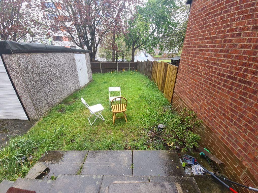Rear garden with a level lawn, paved patio area...