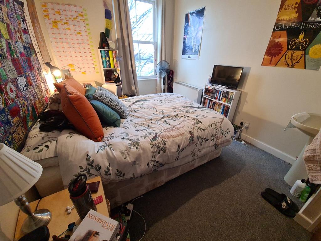 Bright, cosy double bedroom with a patterned be...