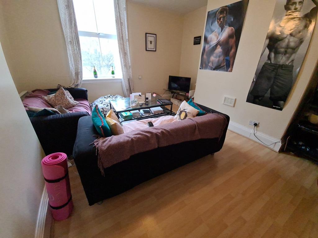 Bright, furnished living room with laminate flo...
