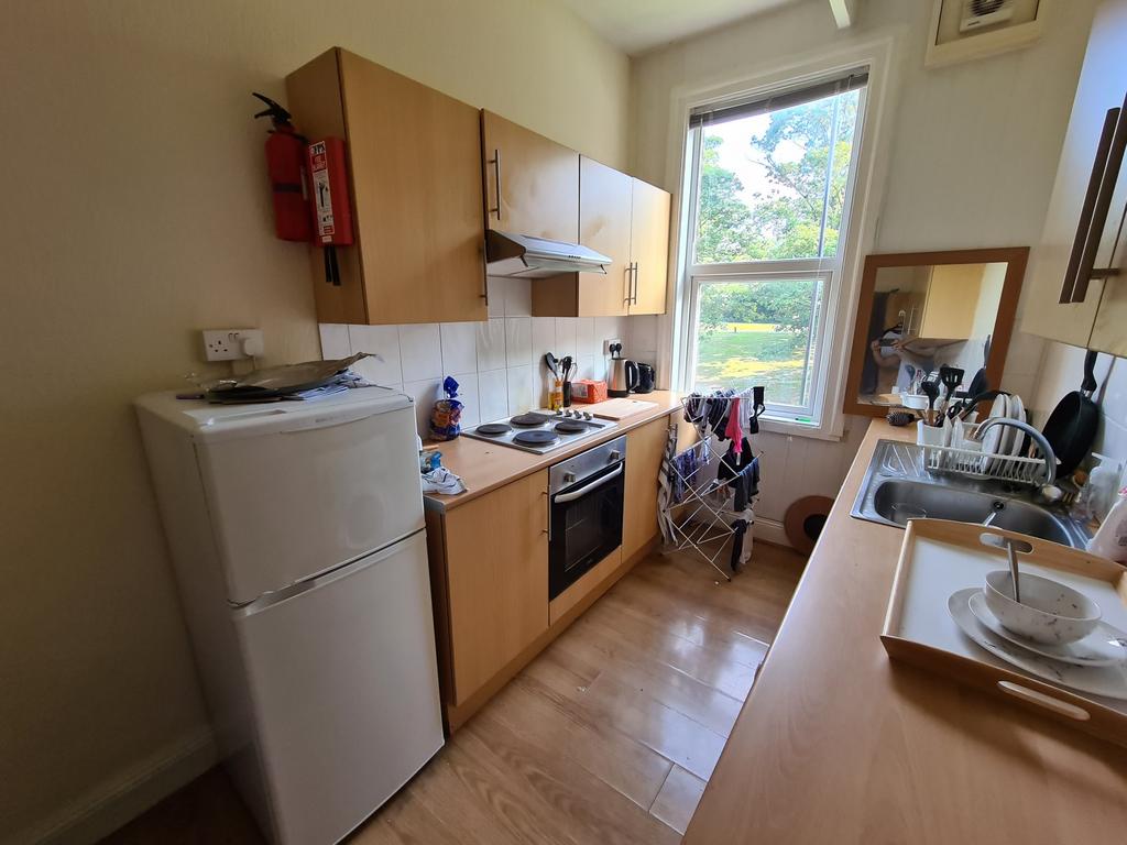 Bright galley kitchen with natural light from a...
