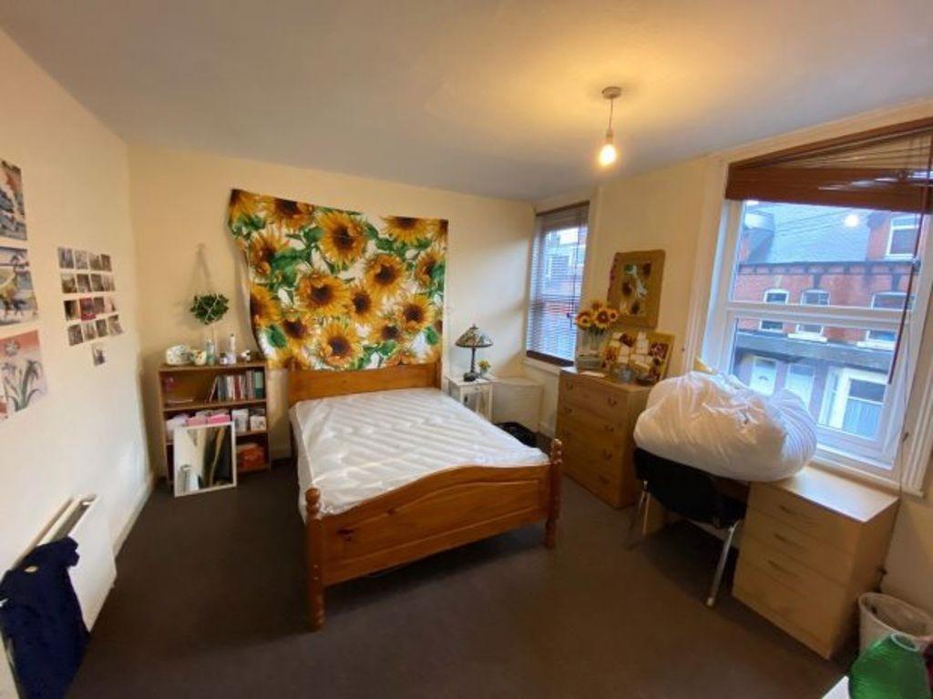 Bright, neatly arranged double bedroom with a w...