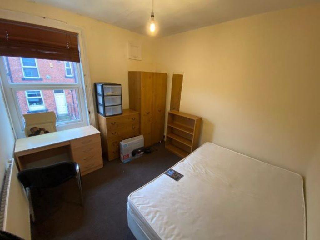 Bright, simply furnished bedroom with a comfort...