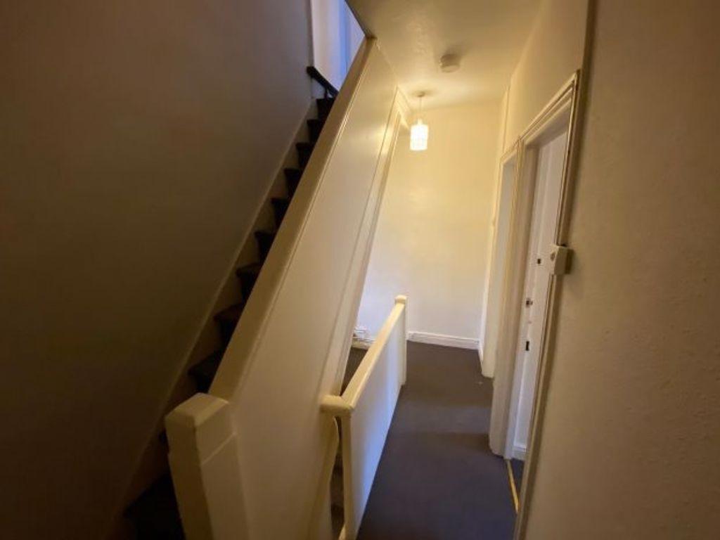 Well-maintained entrance corridor with a stairc...