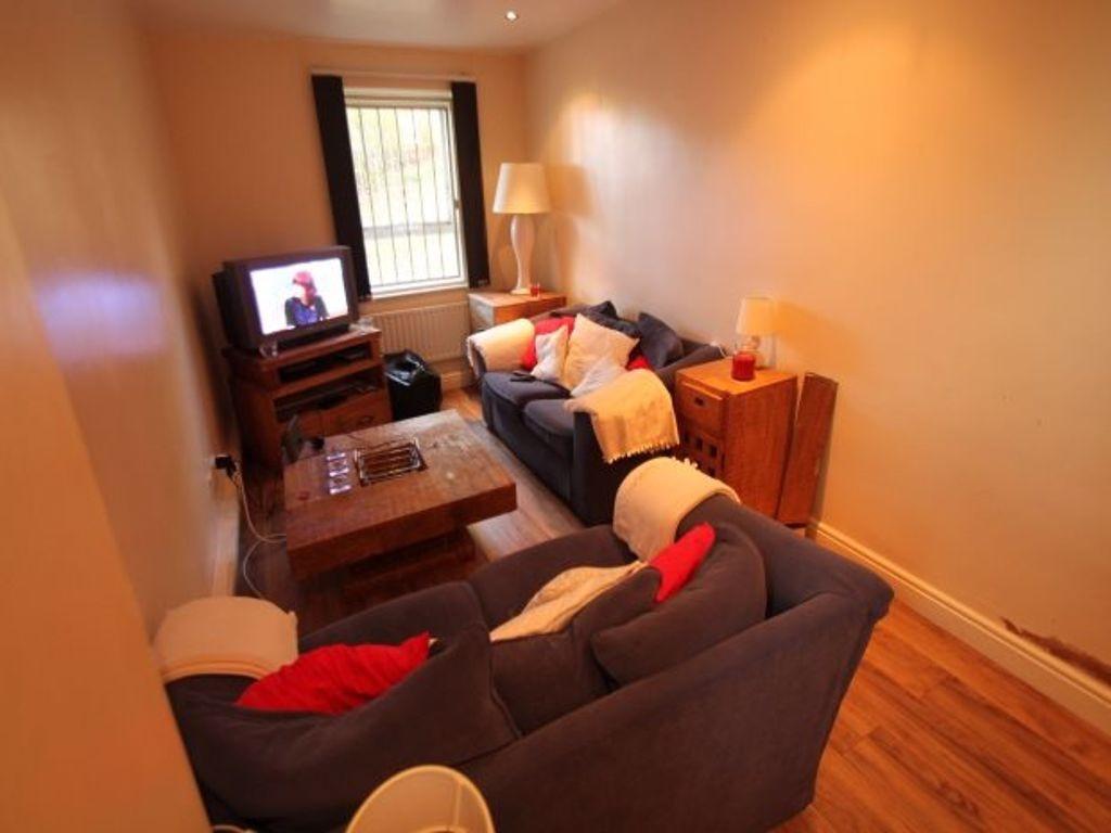 Cozy living room with two sofas, wooden floorin...