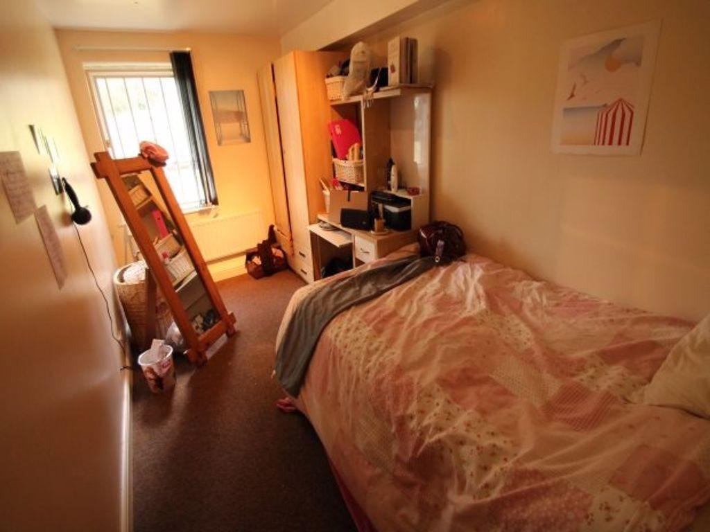 Cozy single bedroom with a comfortable bed, she...
