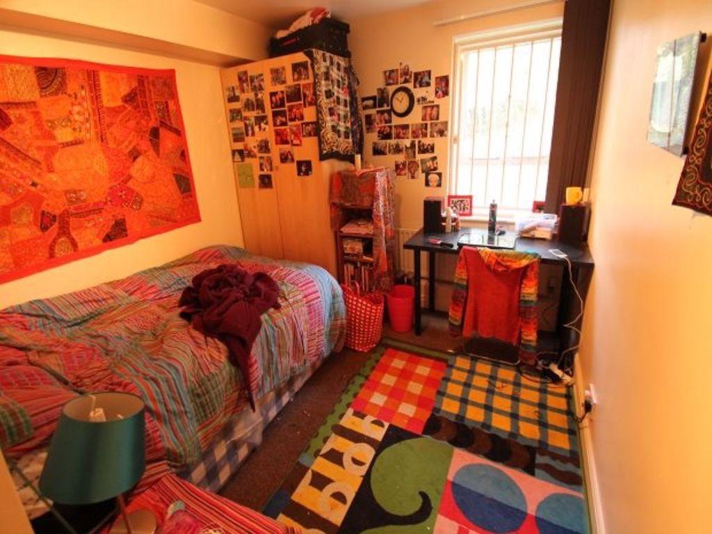 Cozy, colorfully decorated bedroom with vibrant...