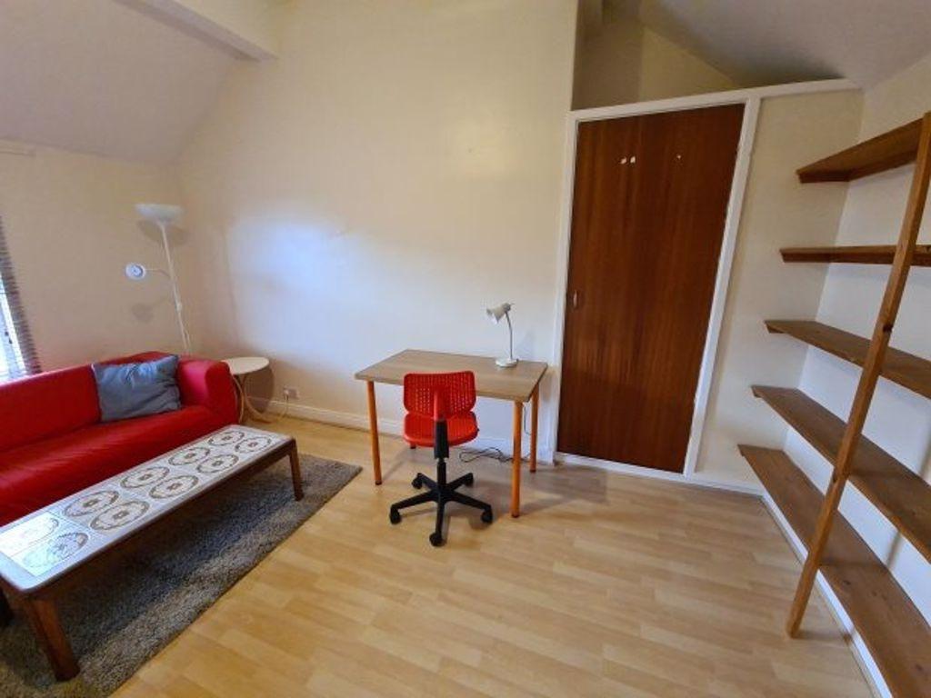 Bright, tidy living area with a red sofa, coffe...