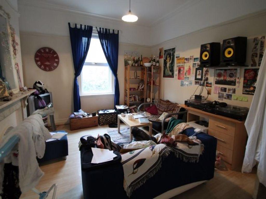 Bright communal living room with a large front ...