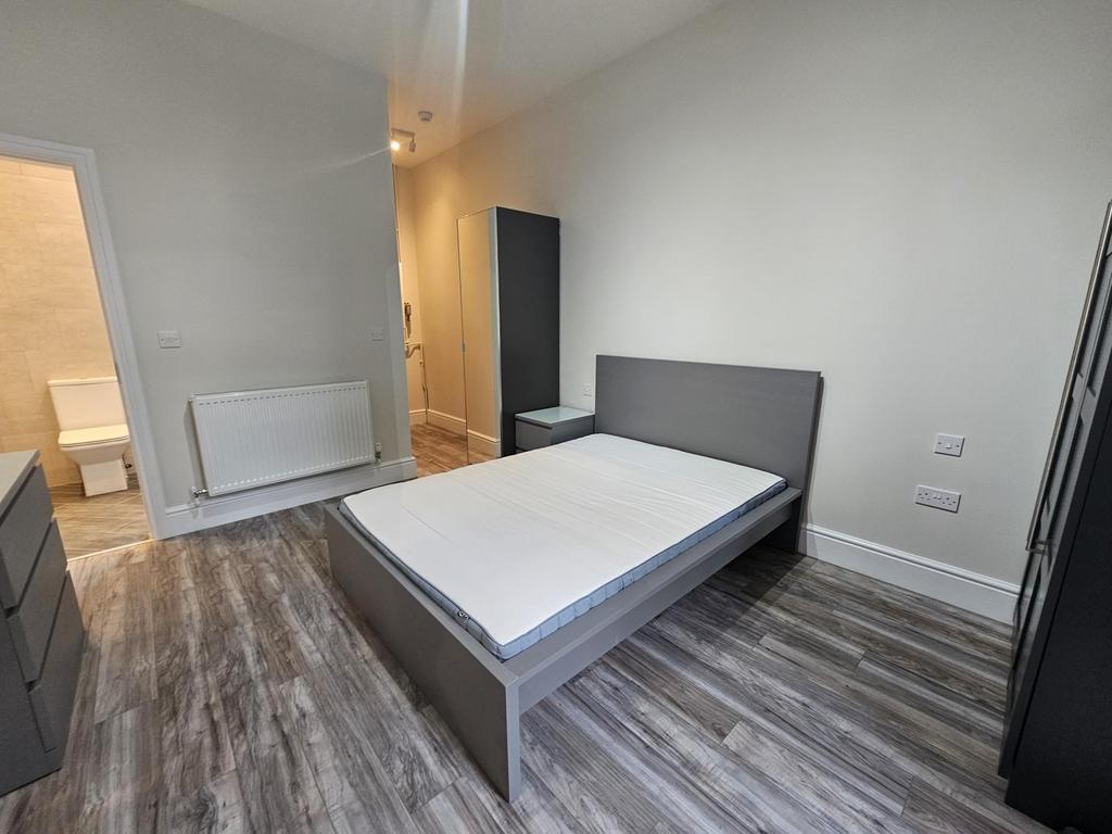Bright, modern bedroom with a double bed, match...
