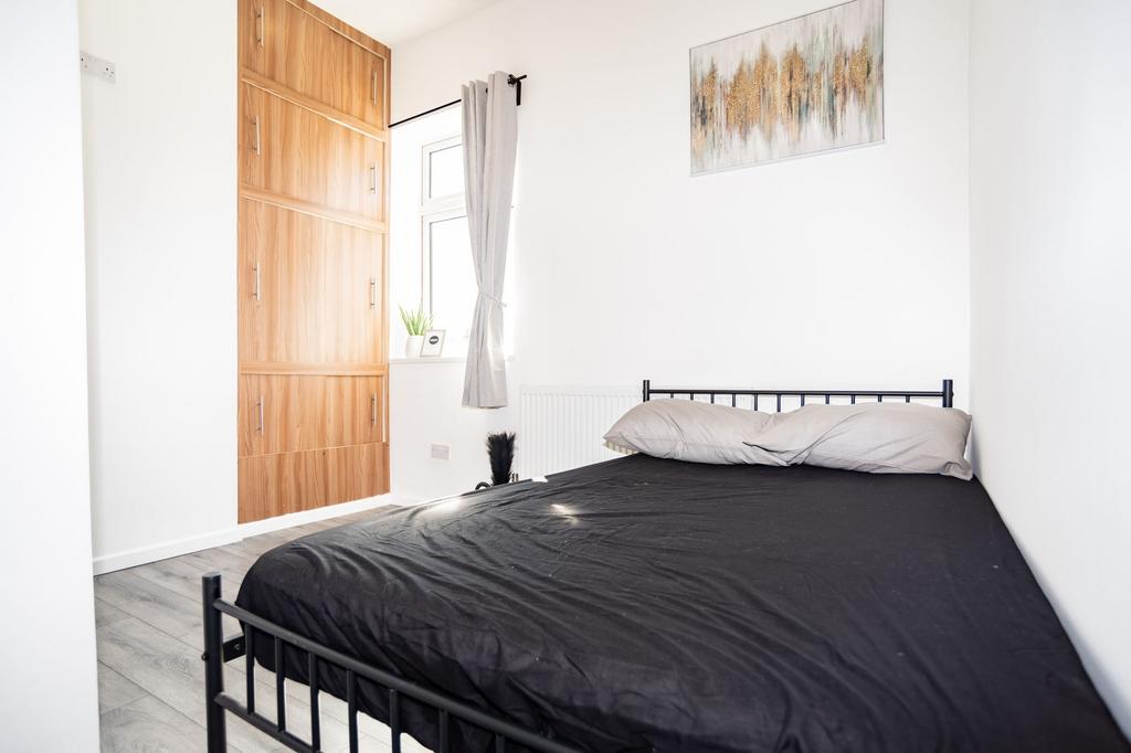 Bright, recently refreshed bedroom with a metal...