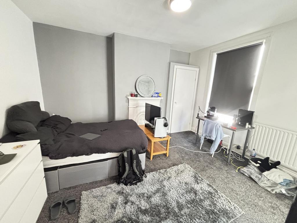 A cozy bedroom featuring a double bed, a wardro...