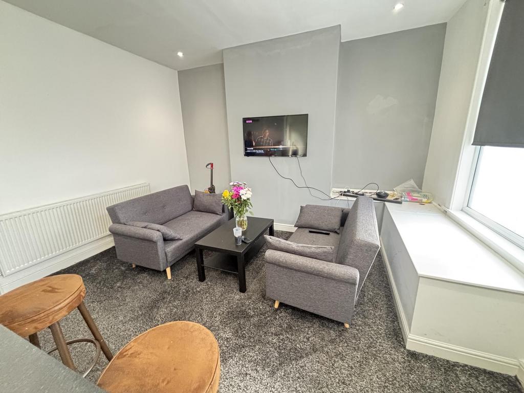 A modern, well-lit living room featuring comfor...