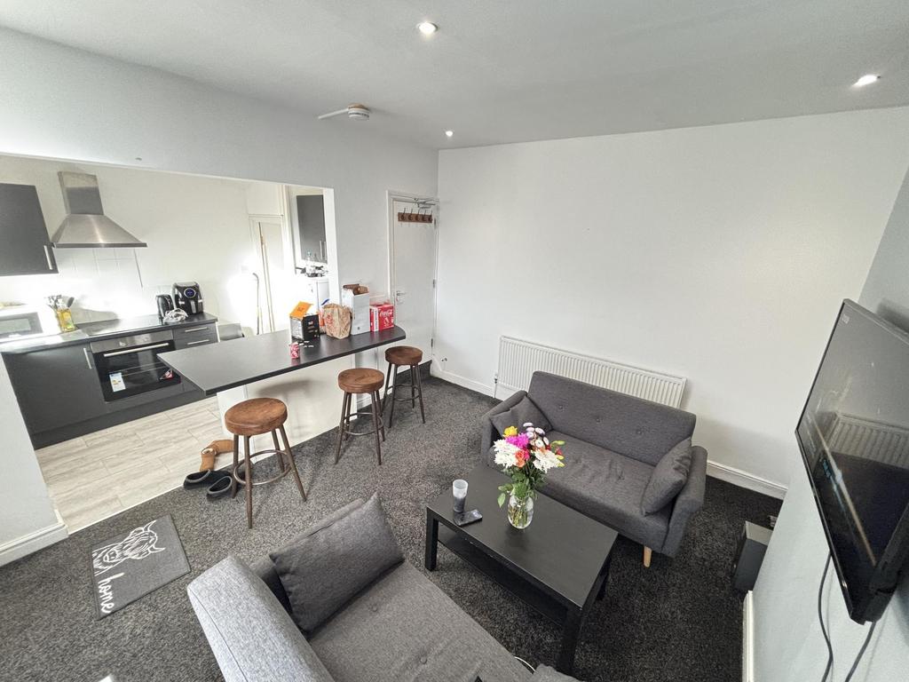 A spacious and welcoming living room featuring ...