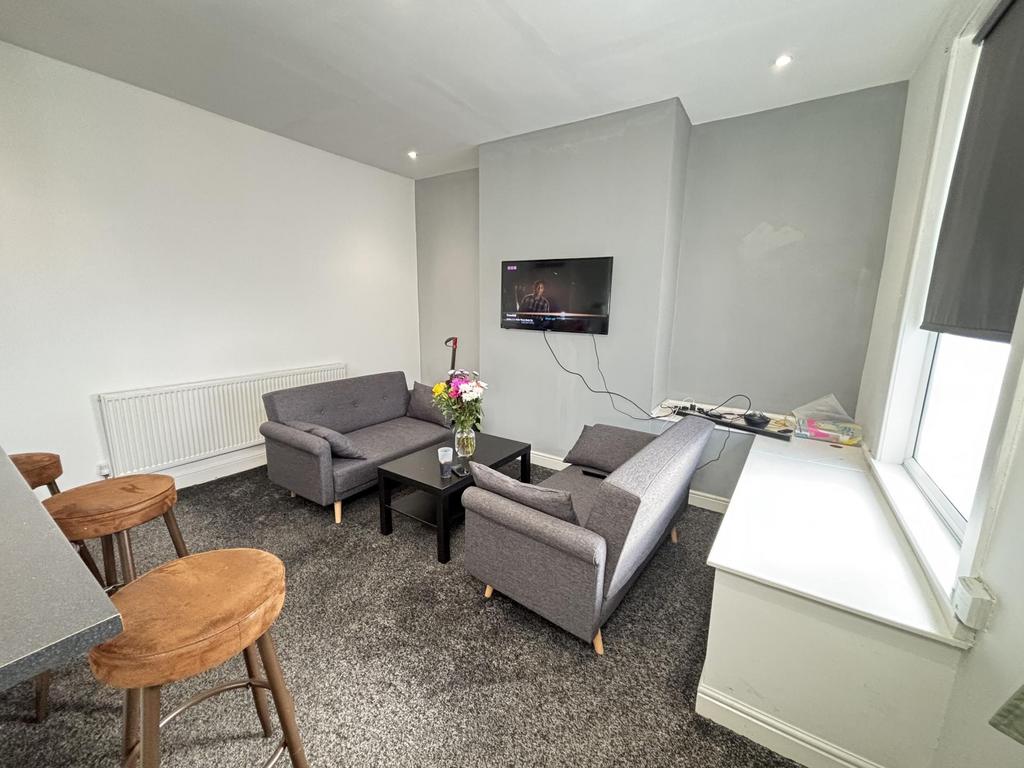 A bright, modern living room featuring a contem...