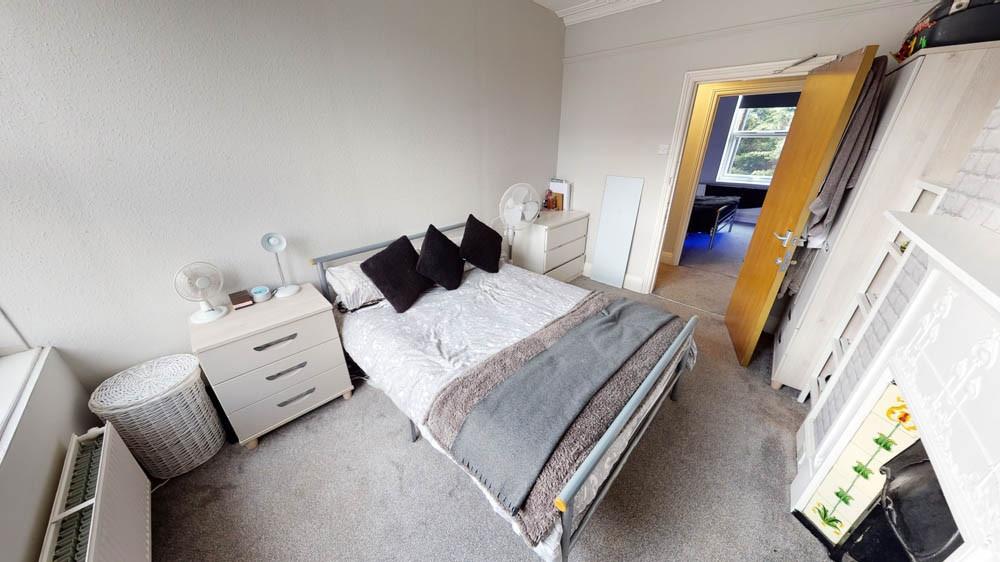 A well-maintained bedroom featuring a comfortab...