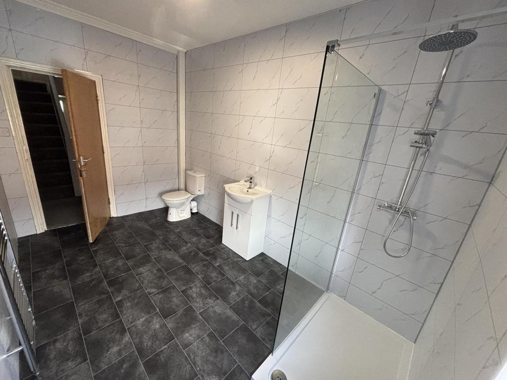A spacious modern bathroom featuring a large wa...
