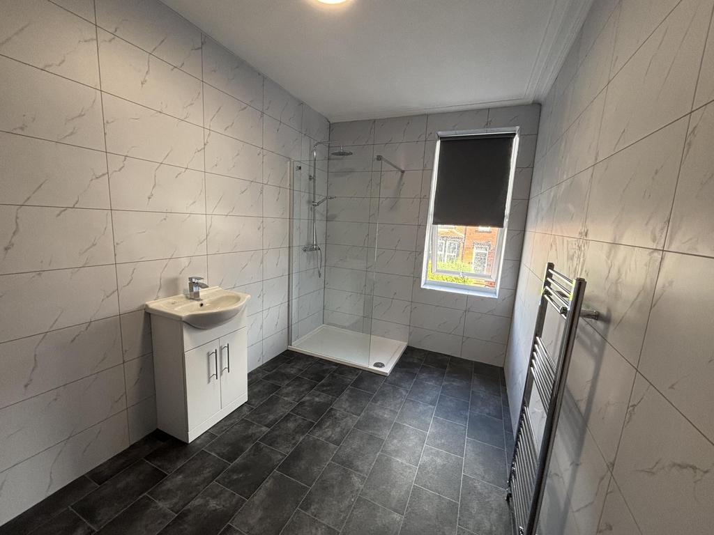 A clean and modern bathroom featuring a large w...