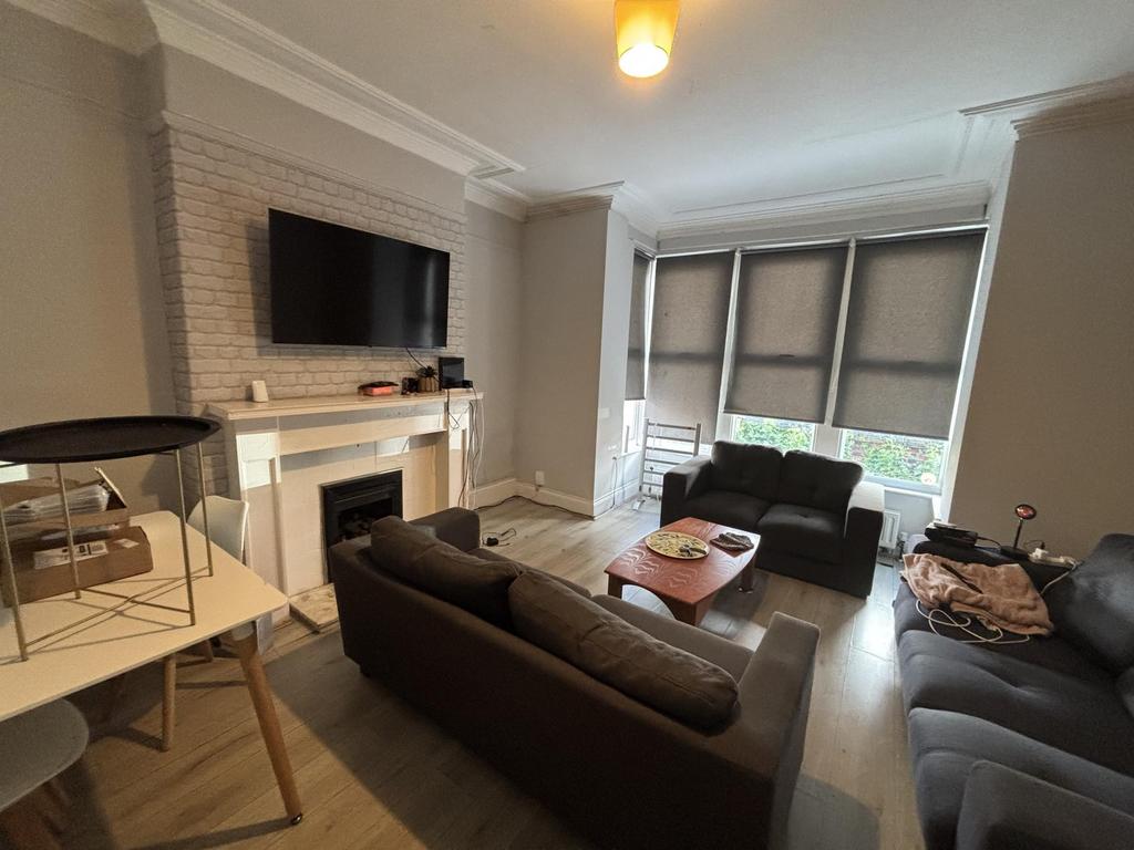 A spacious and well-lit contemporary living roo...