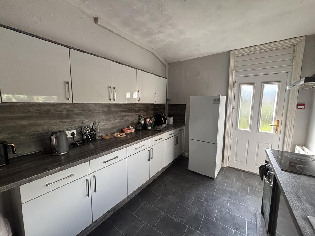 A bright and modern kitchen with ample storage ...