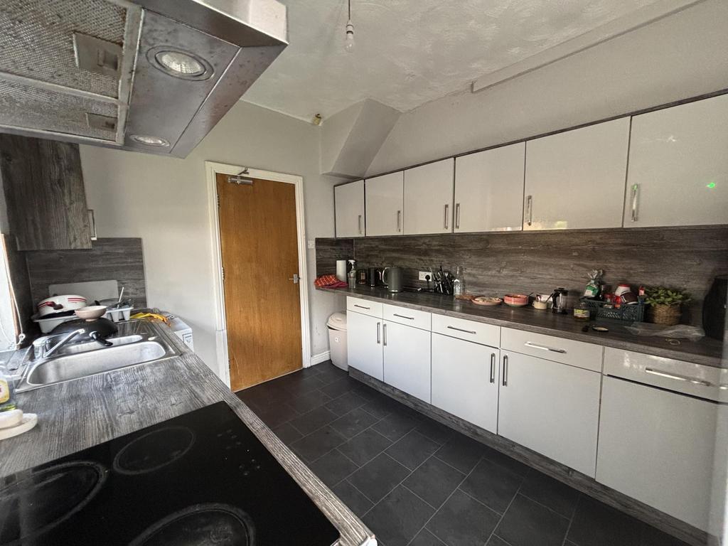 A well-organized kitchen with ample white cabin...