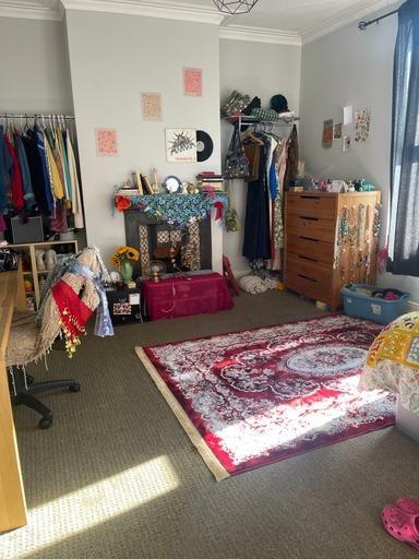 A cozy bedroom with personalized decor, a color...
