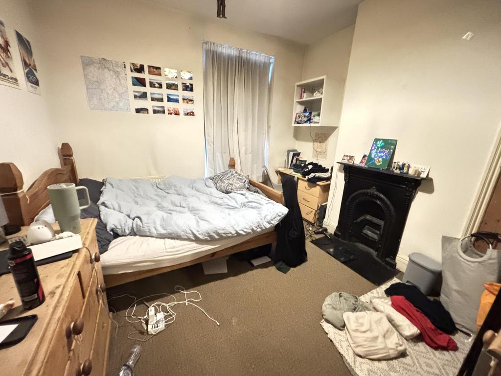 A cozy bedroom featuring a double bed, with nat...