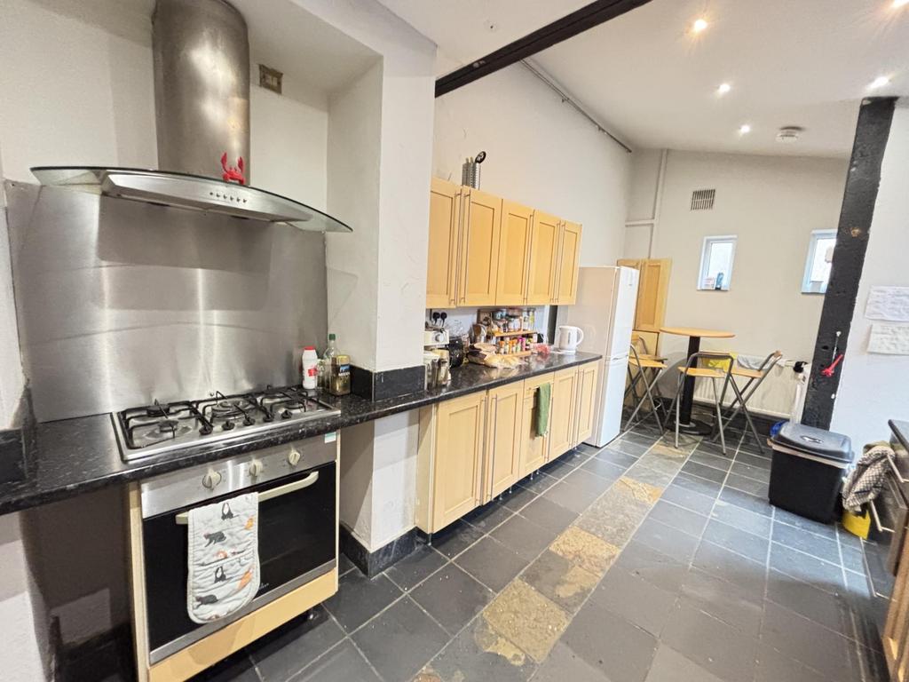 A modern and clean kitchen area featuring woode...