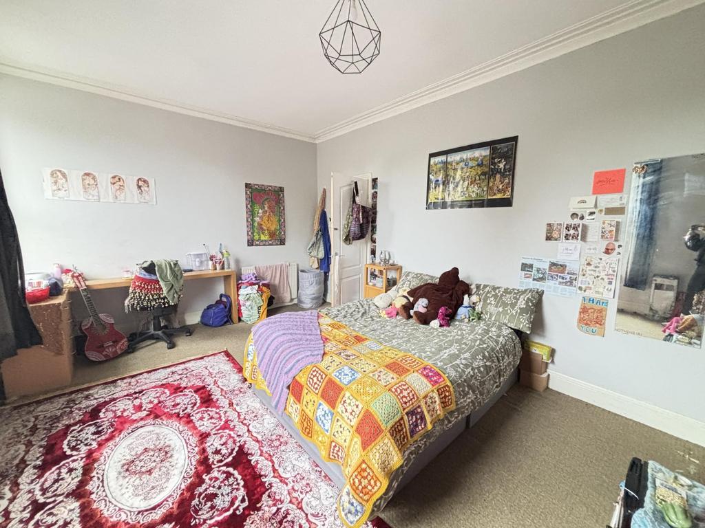 A cozy and well-maintained bedroom with natural...