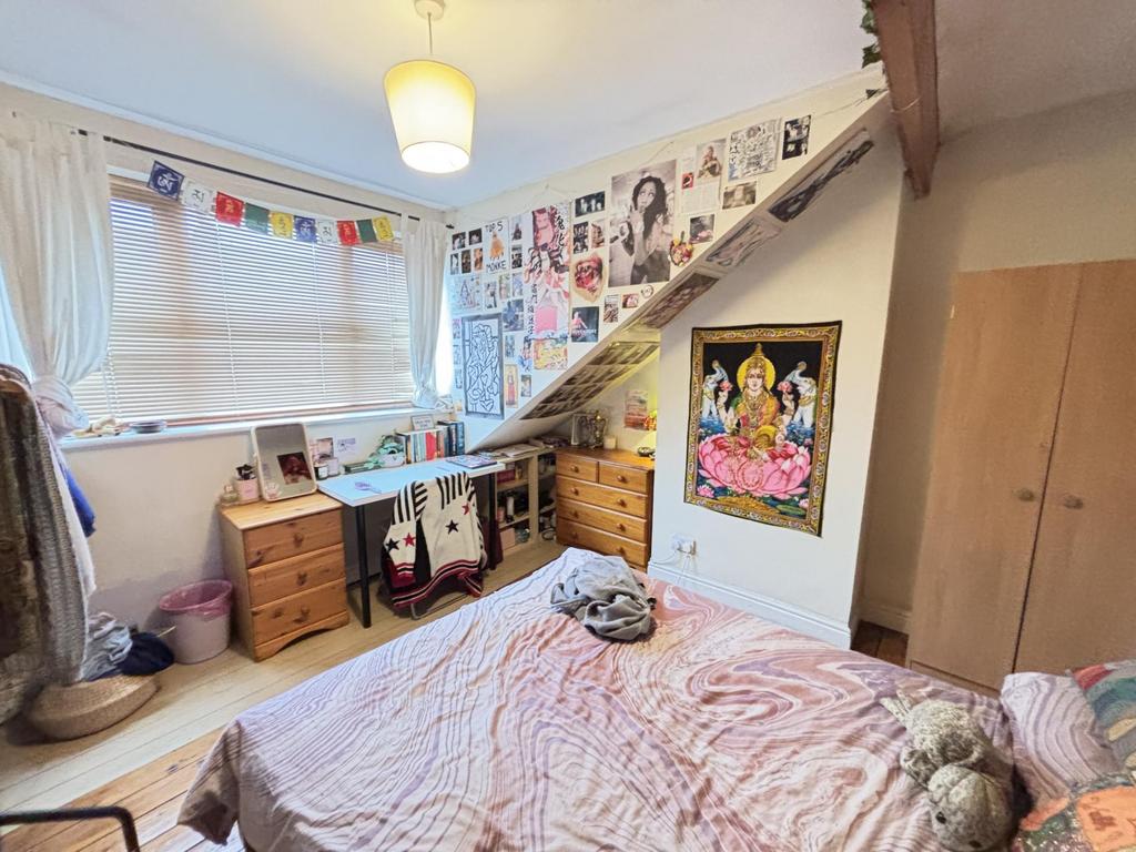 A bright, well-decorated bedroom featuring a co...