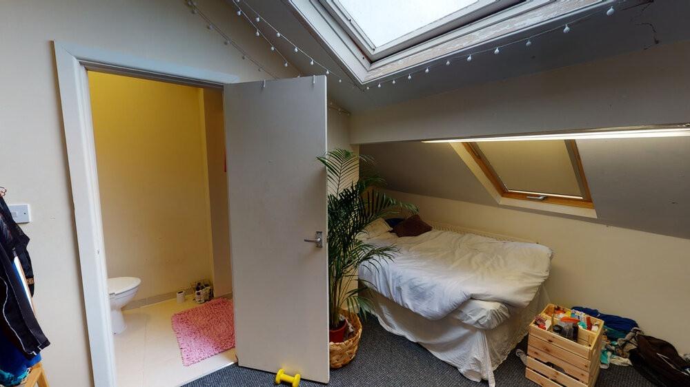 A cozy bedroom with natural light coming throug...