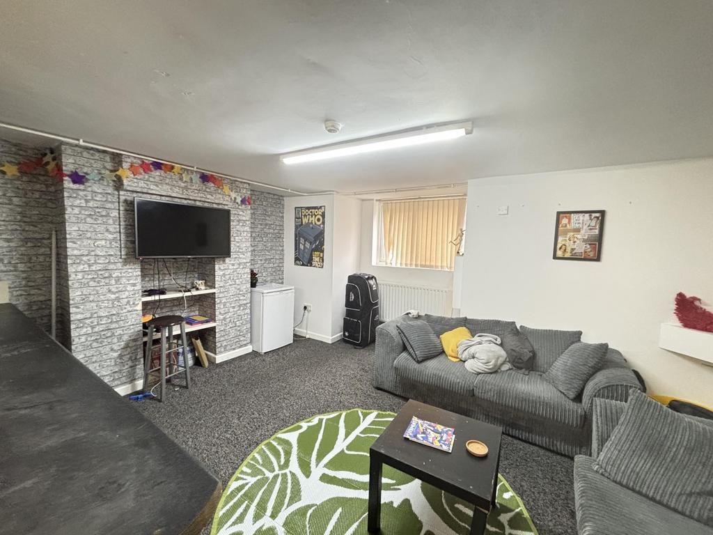 A spacious and welcoming living room featuring ...