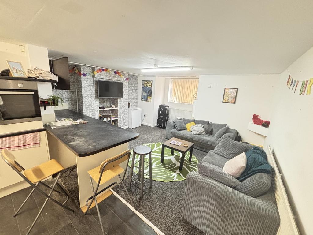 A spacious and modern living room featuring com...