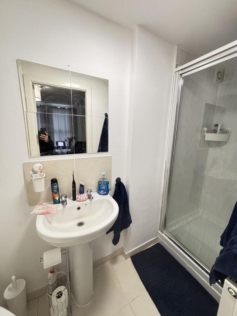 A clean and functional bathroom with a shower e...