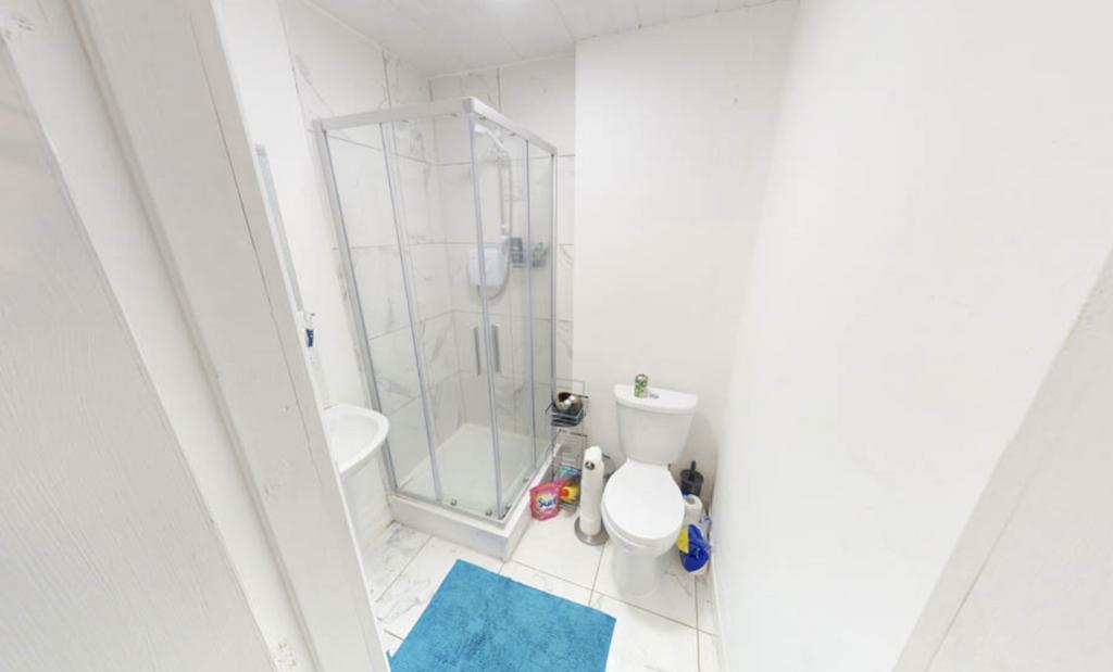 Bright and clean bathroom with a shower enclosu...