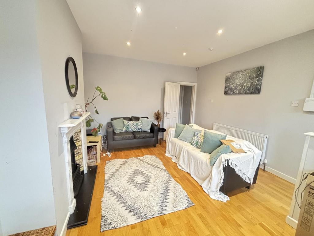A bright and spacious living room featuring com...