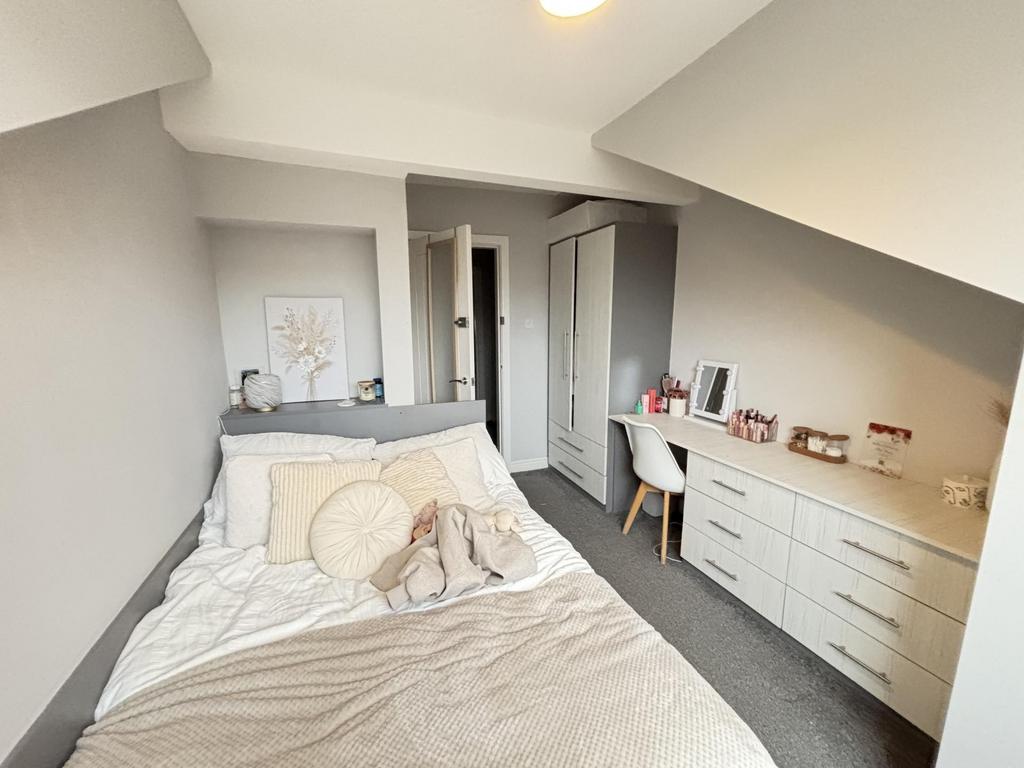 A spacious and inviting master bedroom featurin...