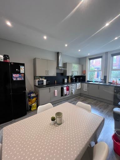 Bright and modern kitchen area with ample natur...