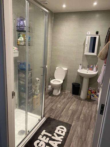 A modern bathroom featuring a shower enclosure,...