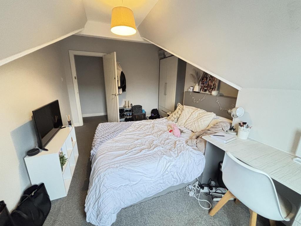 A spacious, well-lit master bedroom featuring a...