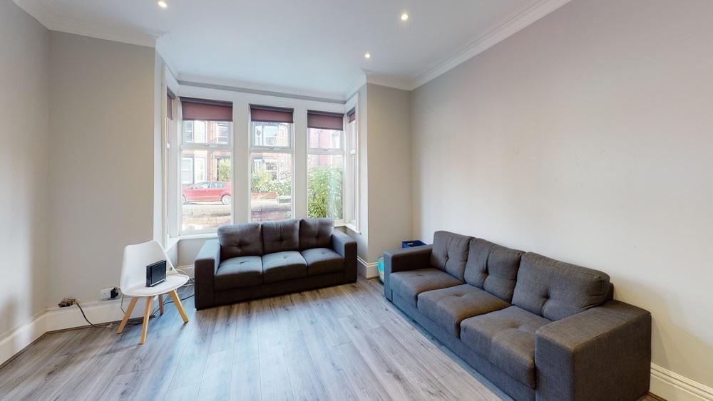 Bright and spacious living room with large wind...