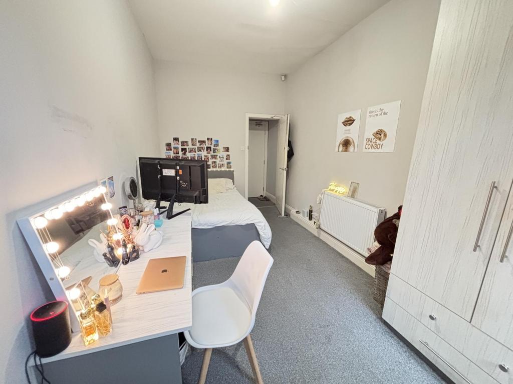 A well-lit, spacious master bedroom featuring a...