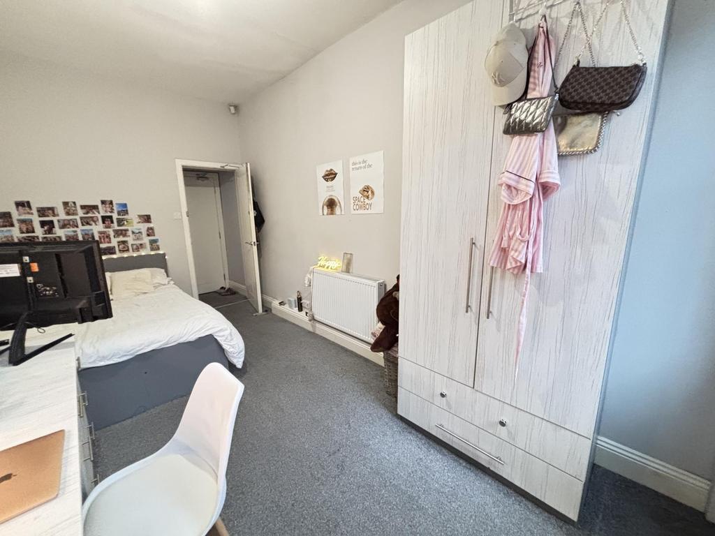 A tidy and well-maintained bedroom featuring a ...