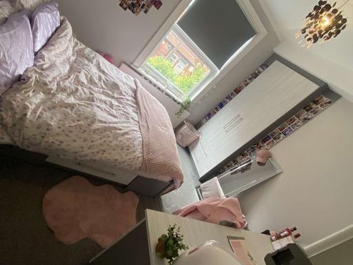 A cozy and tidy bedroom featuring a double bed ...